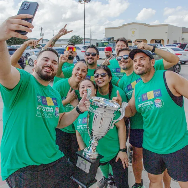 The Bodify community celebrating together with a trophy